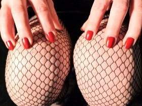 Fishnet stockings and red fingernails