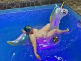 Fun in the pool! Abby on the noble inflatable unicorn
