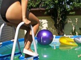 Christina in black vinyl leotard in the pool