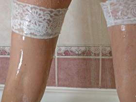 Shower in a white bathing suit, stockings and gymnastic shoes