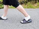 In slippers and white socks in nature