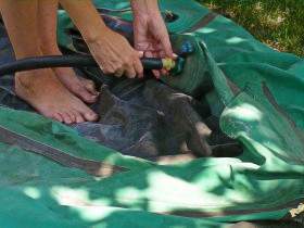 Rubber boat inflated barefoot with rubber pump