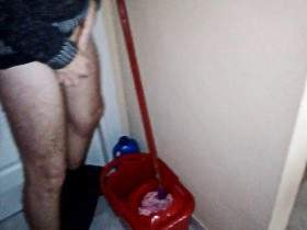 John is taking a Piss into the Cleaning Bucket