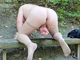 Hot jerking off in pantyhose on bench in the forest