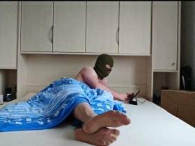 Feet in pantyhose in bed with mask