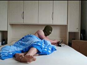 Feet in pantyhose in bed with mask