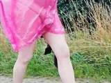 In rain cape, tights and slippers in the drizzle