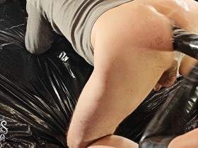 The latex arm deep inside the asshole